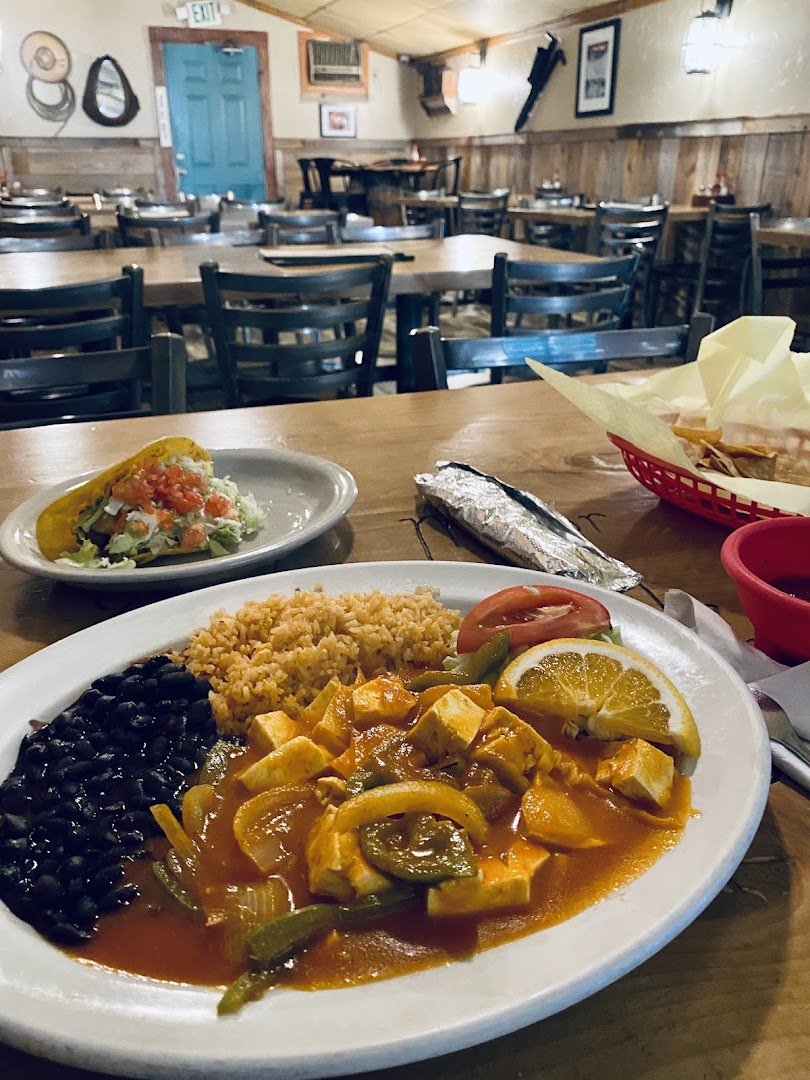 Mexican restaurant interior with traditional decor and seating.